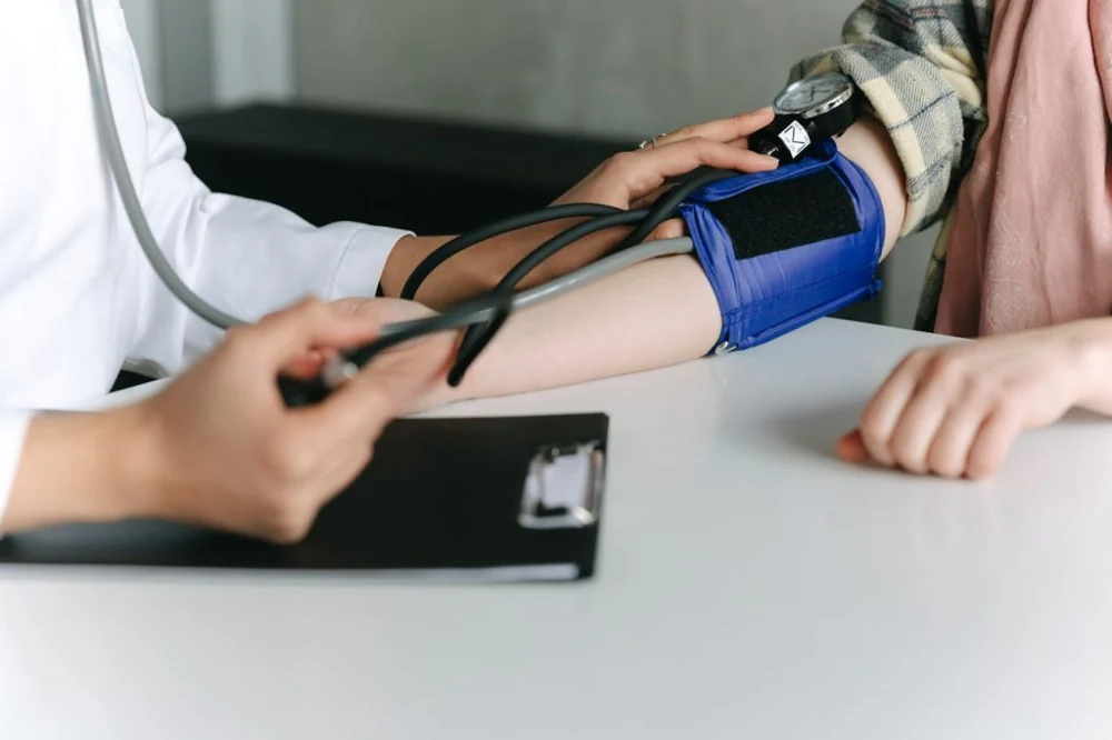 A healthcare provider talking with a patient in an exam room